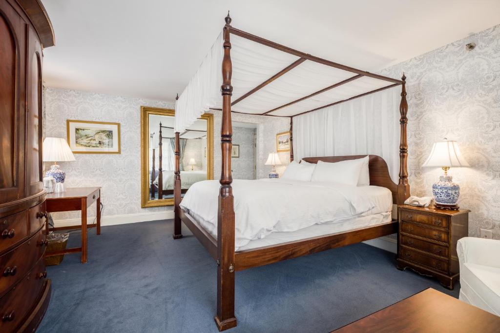 a bedroom with a large bed and a large window at Simsbury 1820 House in Simsbury