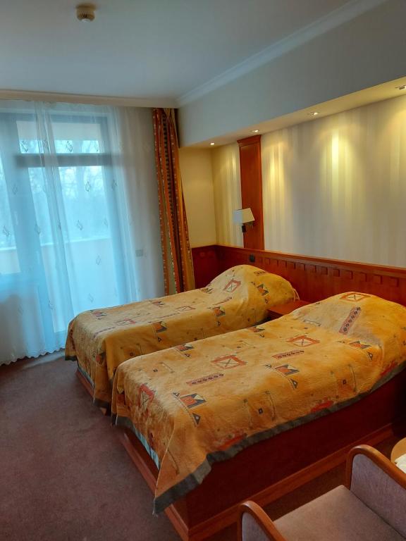 Posteľ alebo postele v izbe v ubytovaní Csipke Hotel