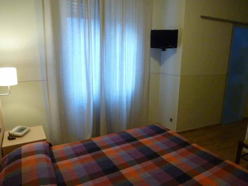Postel nebo postele na pokoji v ubytování Hotel Da Cesare