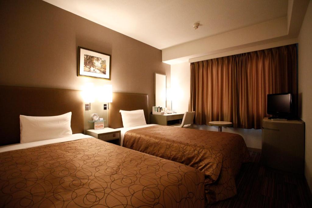 Кровать или кровати в номере Grand Central Hotel