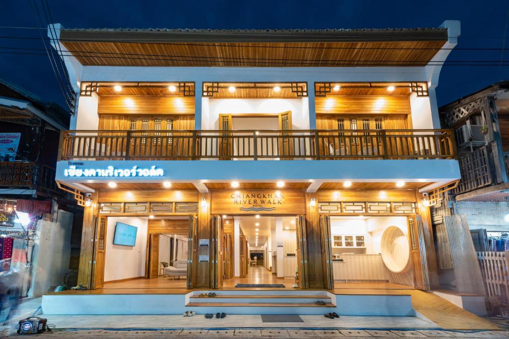 a store front with a bench in front of it at Chiangkhan River Walk Hotel in Chiang Khan