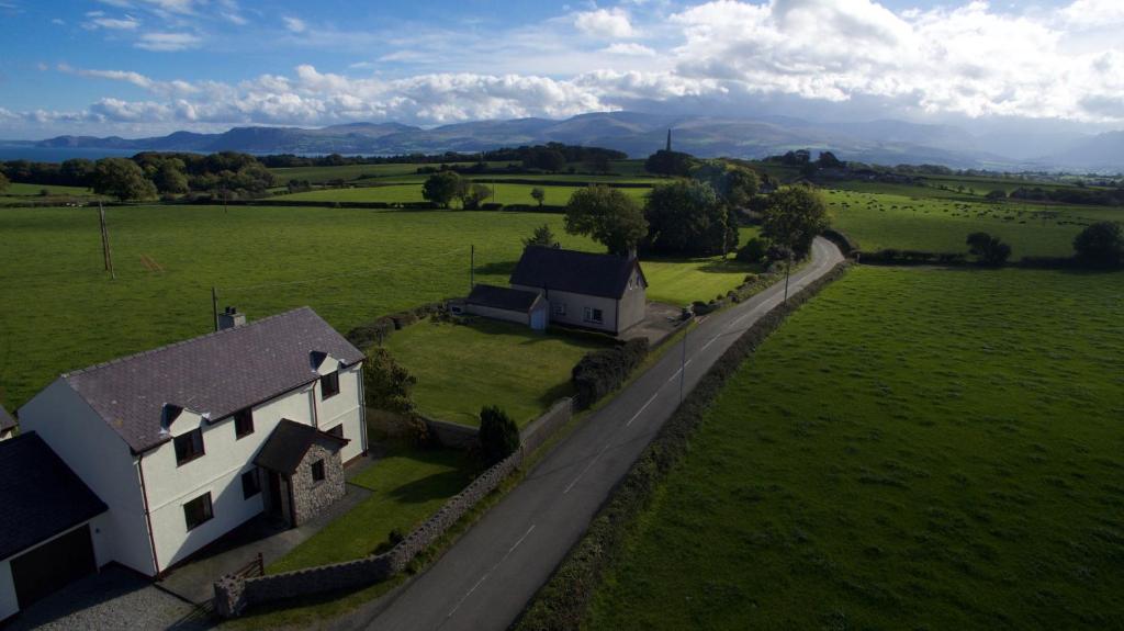 an aerial view of a house in a green field at 4 Bedroom Detached Farmhouse Mountain Views in Beaumaris