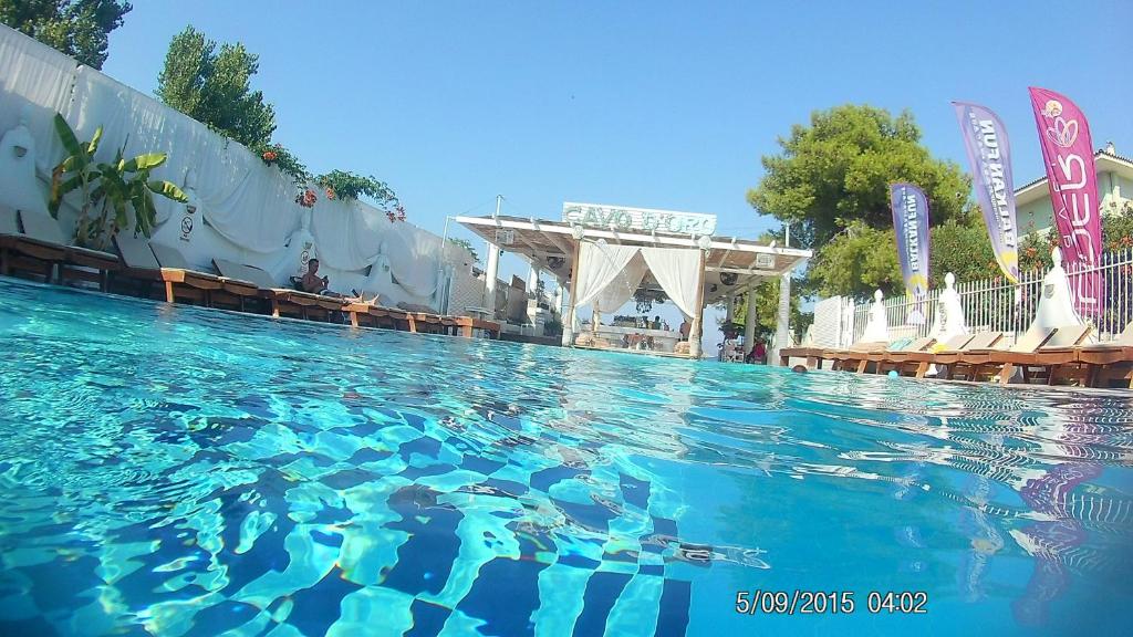 a large pool of blue water in a resort at Cavo D' Oro Complex in Kavos