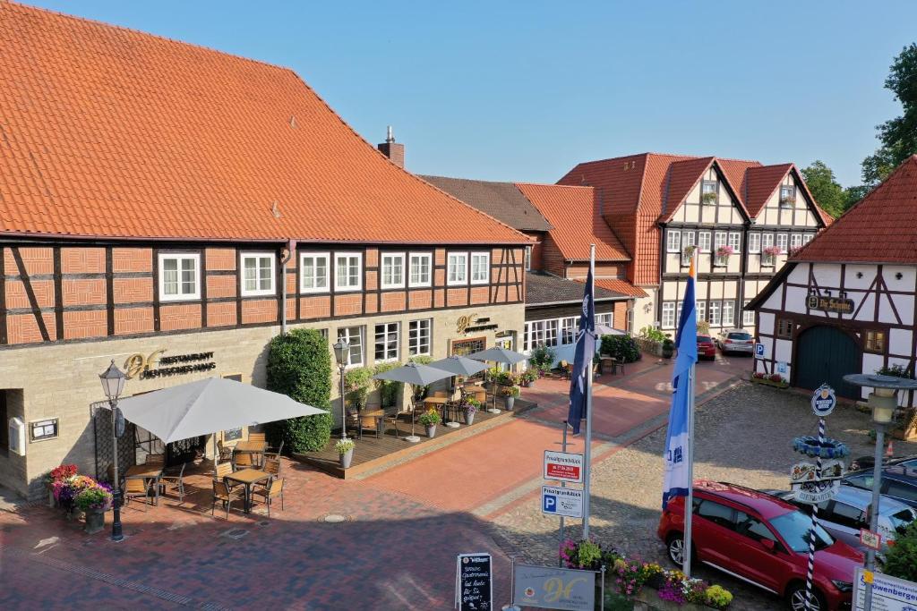 a town with buildings and a street with tables at Hotel Deutsches Haus in Gifhorn