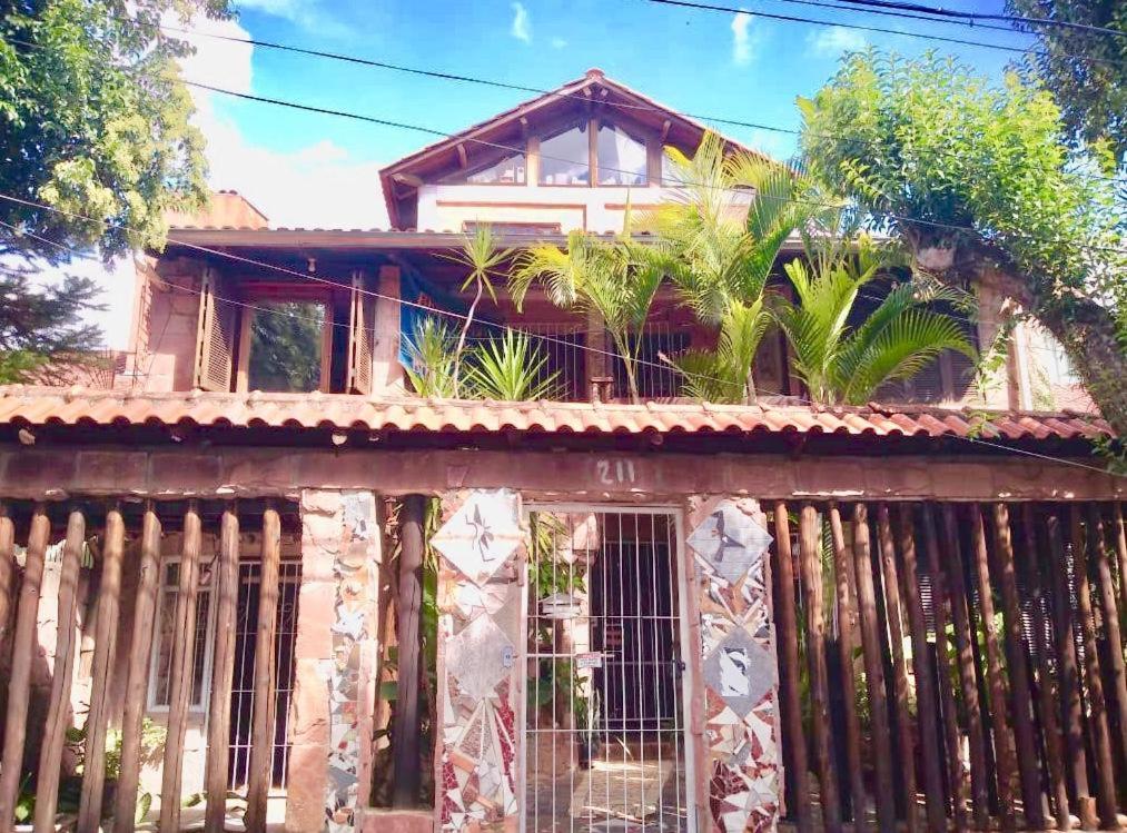 an old house with a fence in front of it at Residentour in Porto Alegre