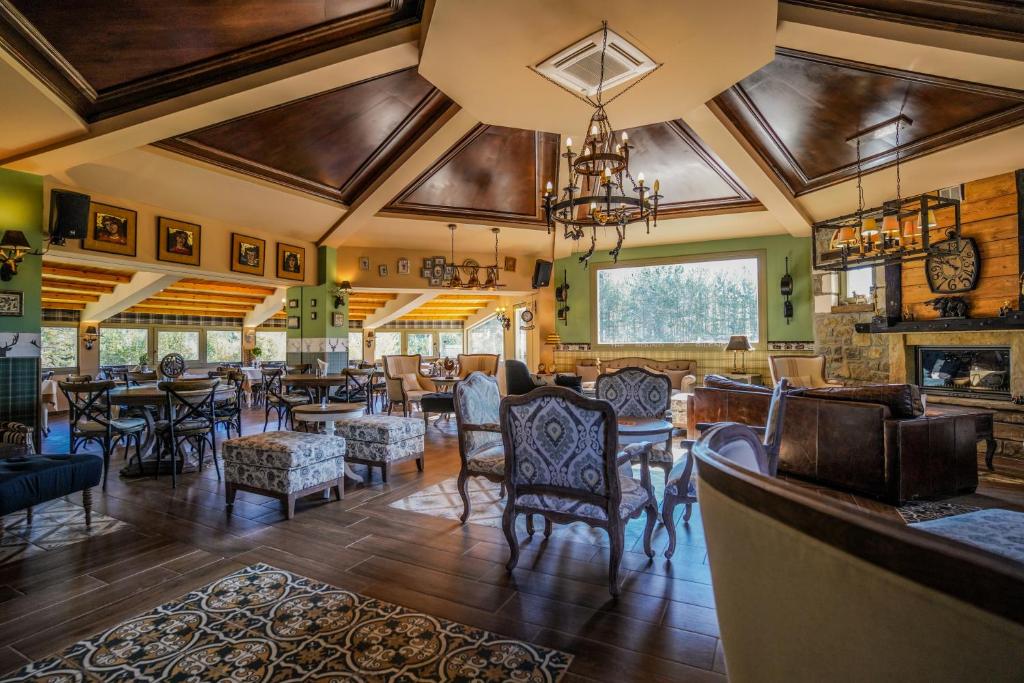 a restaurant with tables and chairs and a bar at Pindos Resort in Kraniá