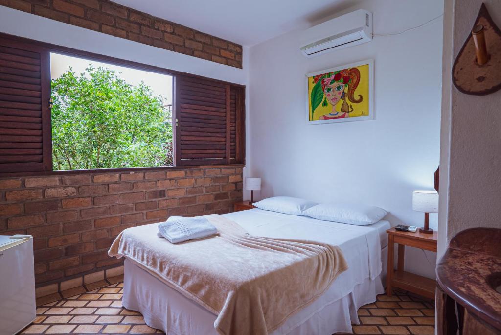 Cama ou camas em um quarto em Pousada Alto do Cajueiro