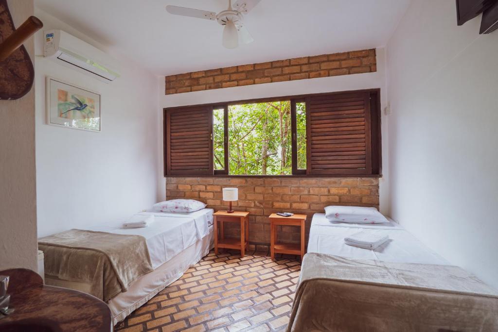 Cama ou camas em um quarto em Pousada Alto do Cajueiro