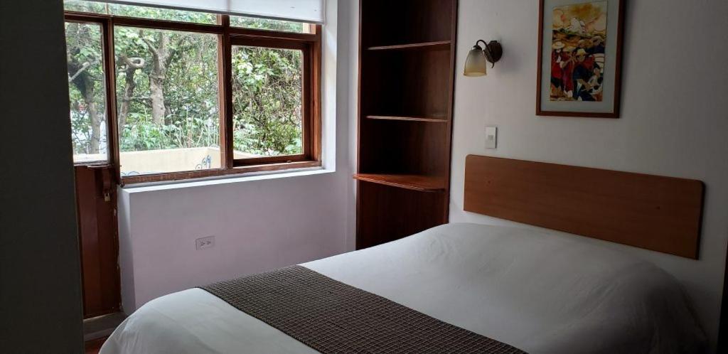 Postel nebo postele na pokoji v ubytování Hostal Posada del Maple