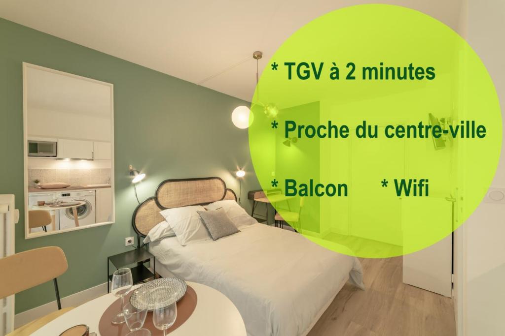 a bedroom with a bed and a green circle with the words try a minutes at apparthotel-gare-chambery in Chambéry