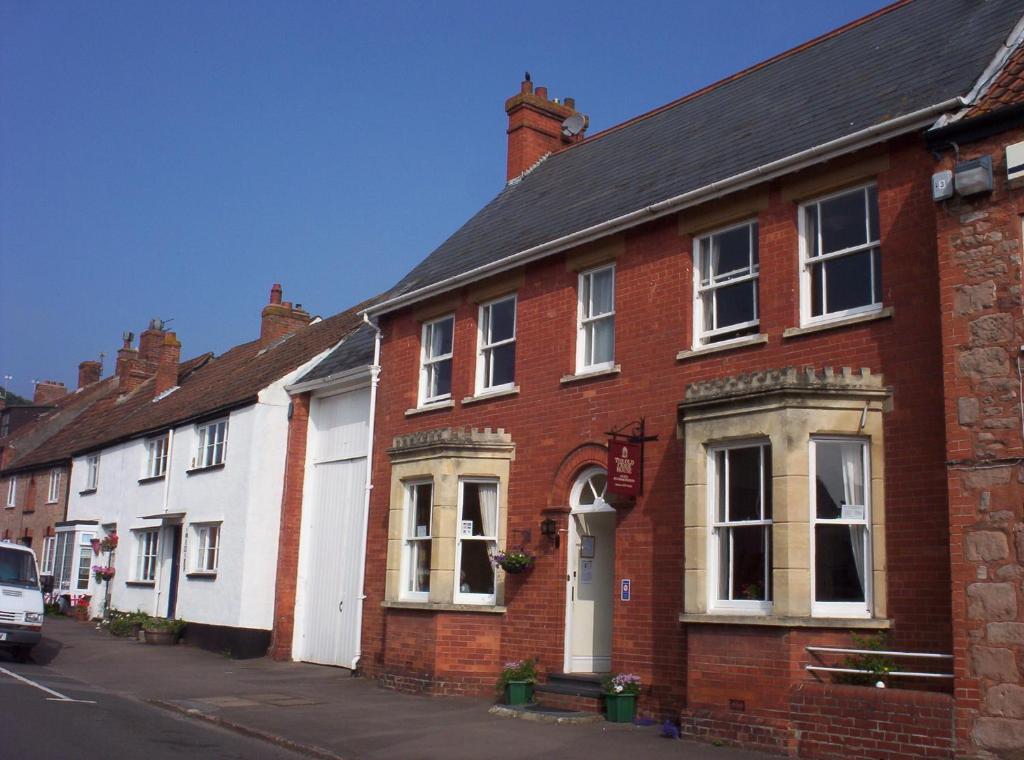 a row of brick houses on a street at The Old Cider House in Nether Stowey