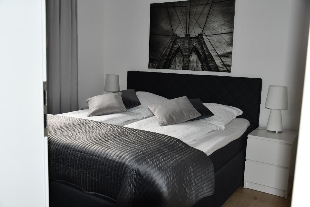 a black and white bedroom with a large bed at Vicky´s Ferienwohnung Am Nordertor in Flensburg