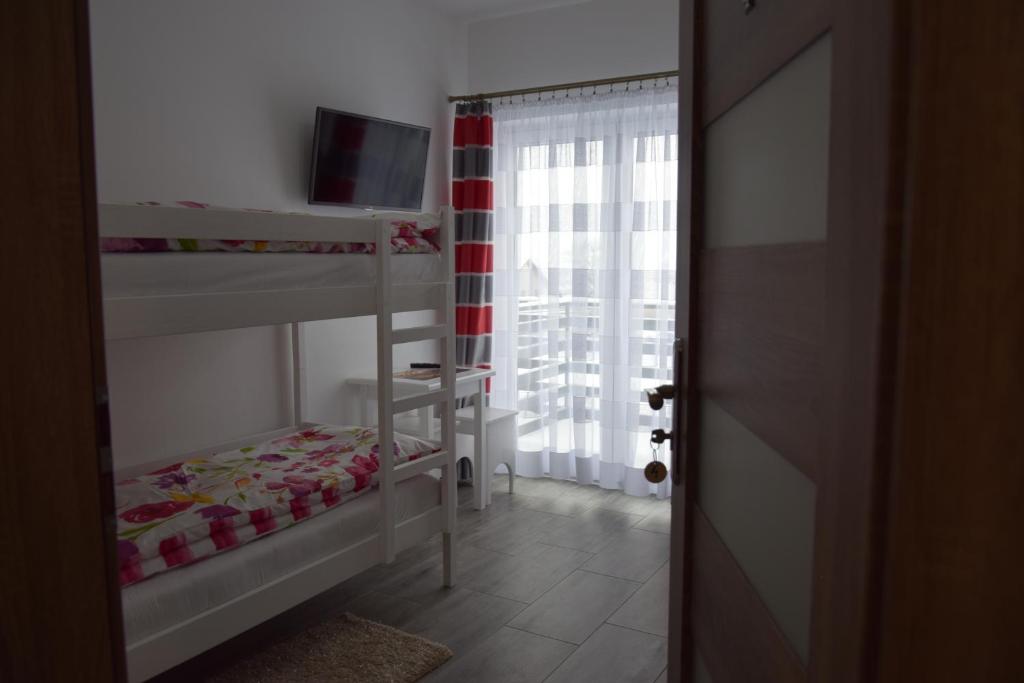Posteľ alebo postele v izbe v ubytovaní Noclegi u Eweliny