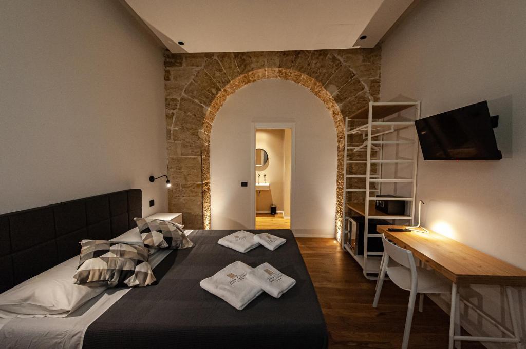 a bedroom with a bed with two towels on it at Palazzo al Carmine in Monreale