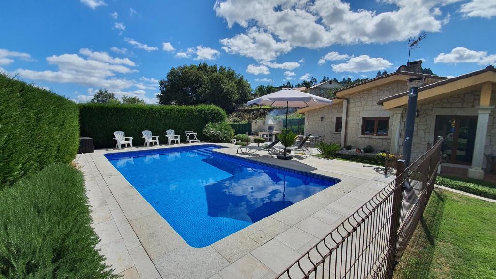 una piscina en un patio con una valla en Casa Pinzón, en Puente Caldelas
