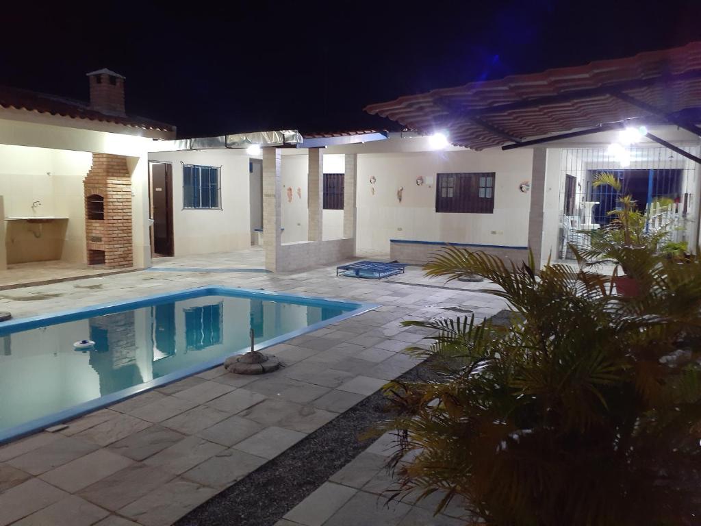 a house with a swimming pool at night at Casa de Praia com Piscina- 18 hóspedes- Não é Condomínio- Fibra Ótica- Praia dos Golfinhos- Itamaracá in Itamaracá