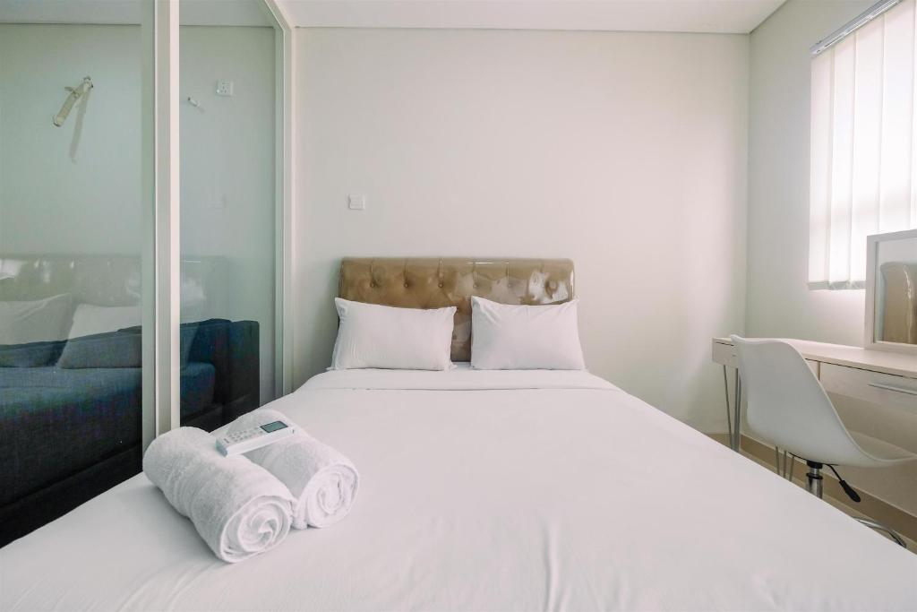 Ένα ή περισσότερα κρεβάτια σε δωμάτιο στο Elegant with Modern Design 1BR Apartment at Atlanta Residences By Travelio