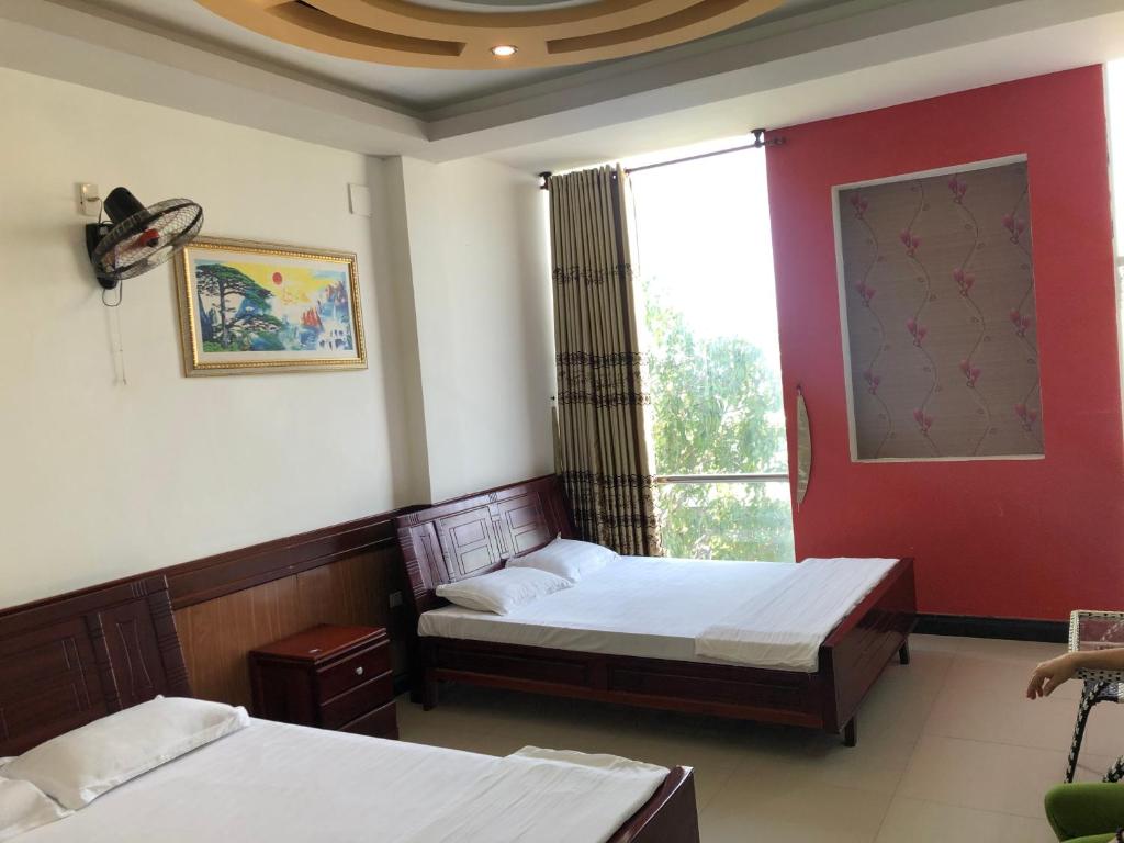 Hong Dao Hotel tesisinde bir odada yatak veya yataklar
