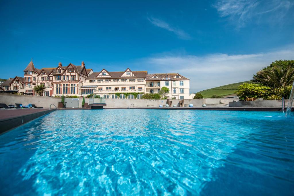 a large swimming pool in front of a large building at The Woolacombe Bay Hotel in Woolacombe