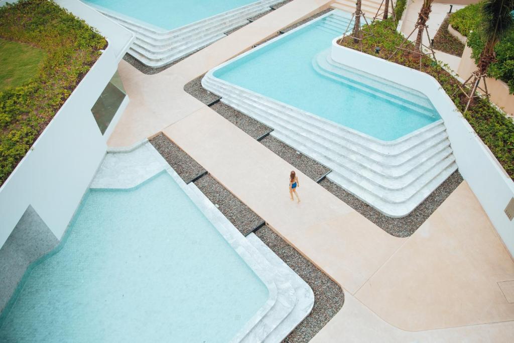 an overhead view of a swimming pool at a resort at VERSO Hua Hin - a Veranda Collection - SHA Extra Plus in Hua Hin