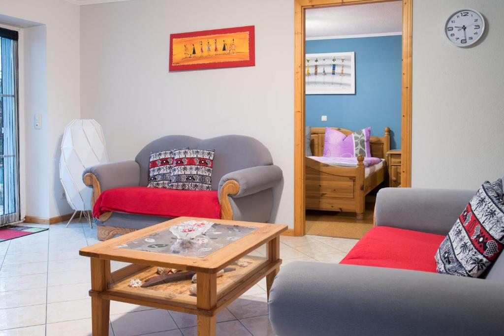 a living room with two couches and a coffee table at Ferienwohnung in Bad Staffelstein OT Grundfeld in Bad Staffelstein