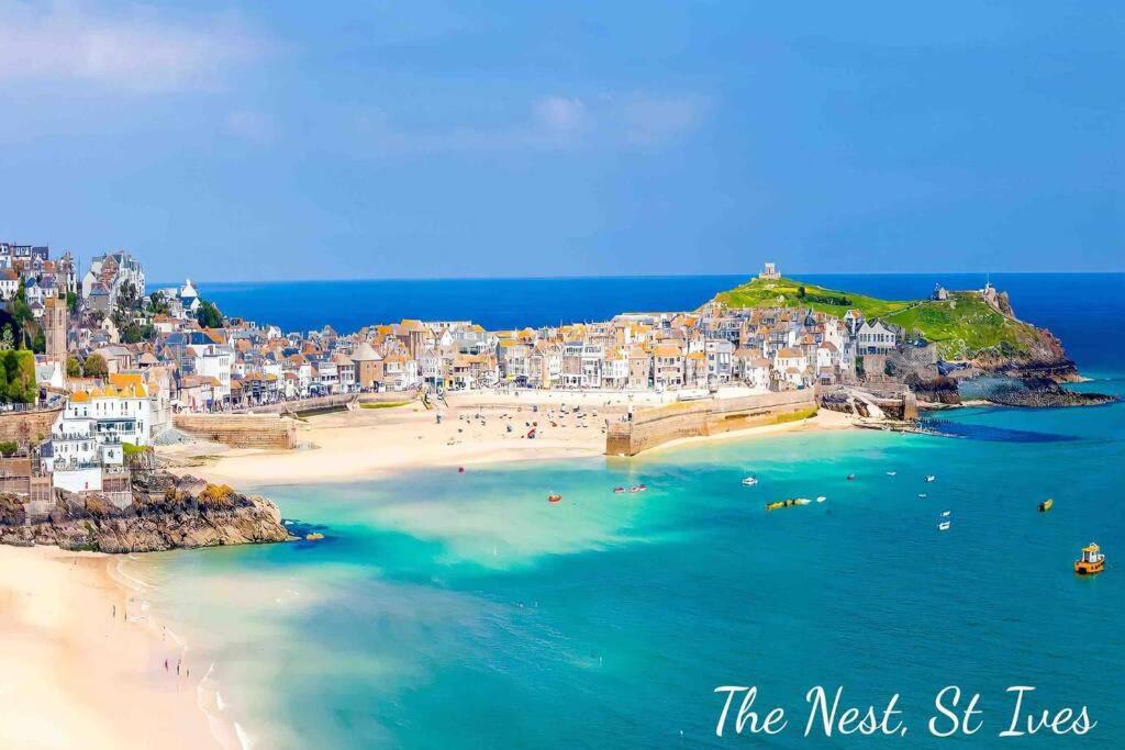 a view of a beach with people in the water at The Nest - St Ives in St Ives