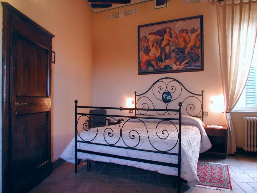 Postel nebo postele na pokoji v ubytování Albergo Il Giglio
