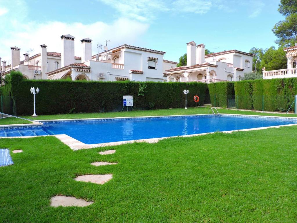 a swimming pool in the yard of a house at Doree 540 in Miami Platja