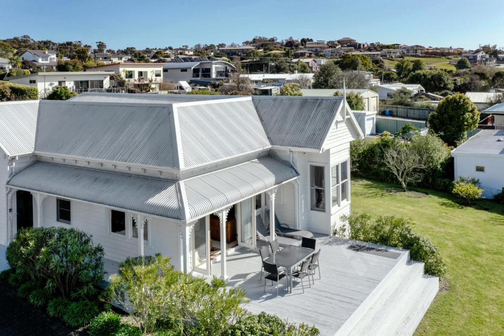 an aerial view of a white house with a roof at Bridport Beach House in Bridport