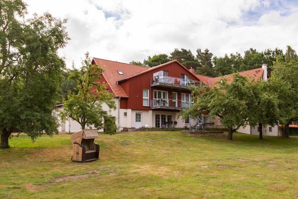 una casa grande con un patio con una casa de aves en Usedom Landhaus Morgenitz, en Morgenitz