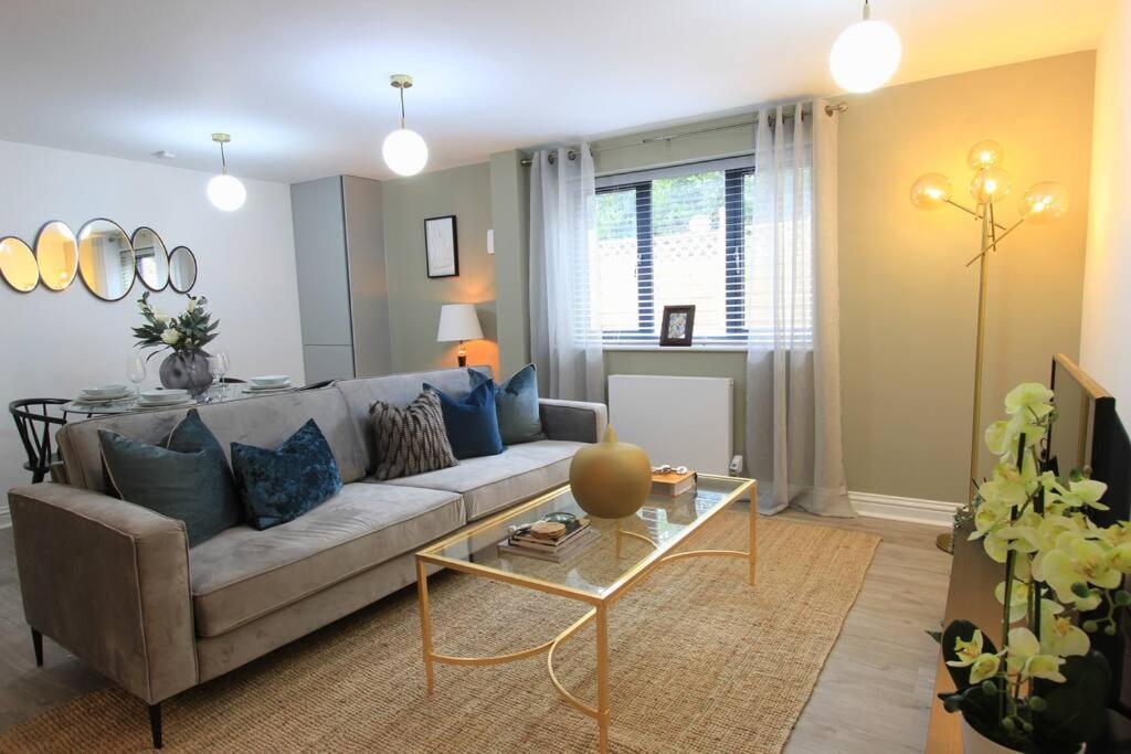 a living room with a couch and a table at Cabot Mews Apartment 2 in Bristol