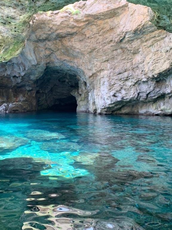 a cave in the middle of a body of water at La maison du vent in Marettimo