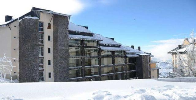 a large building in the snow with snow at Miramar Ski - your home away from home - in Sierra Nevada