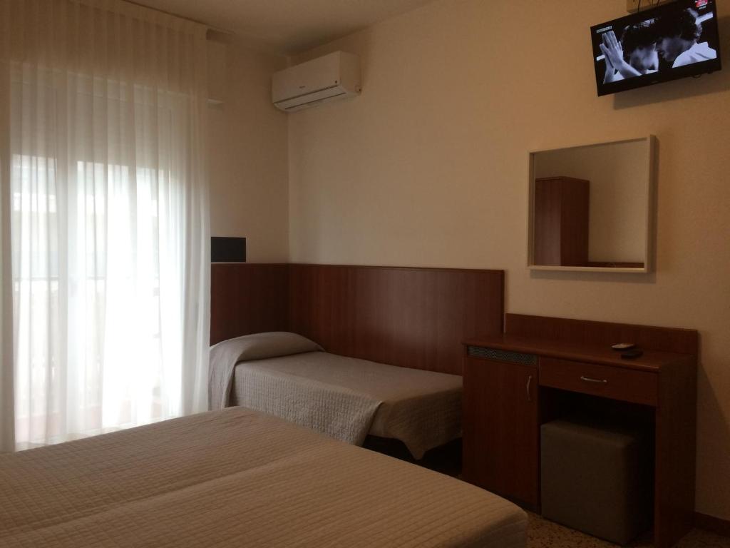 Postel nebo postele na pokoji v ubytování Hotel Portofino