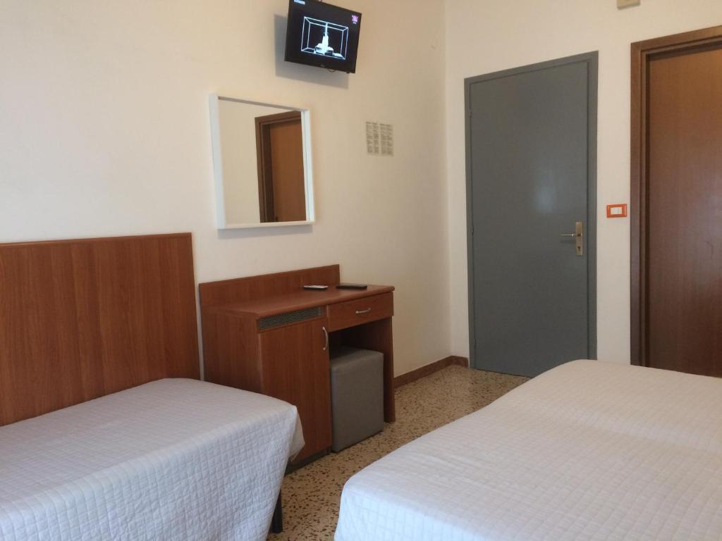 Postel nebo postele na pokoji v ubytování Hotel Portofino