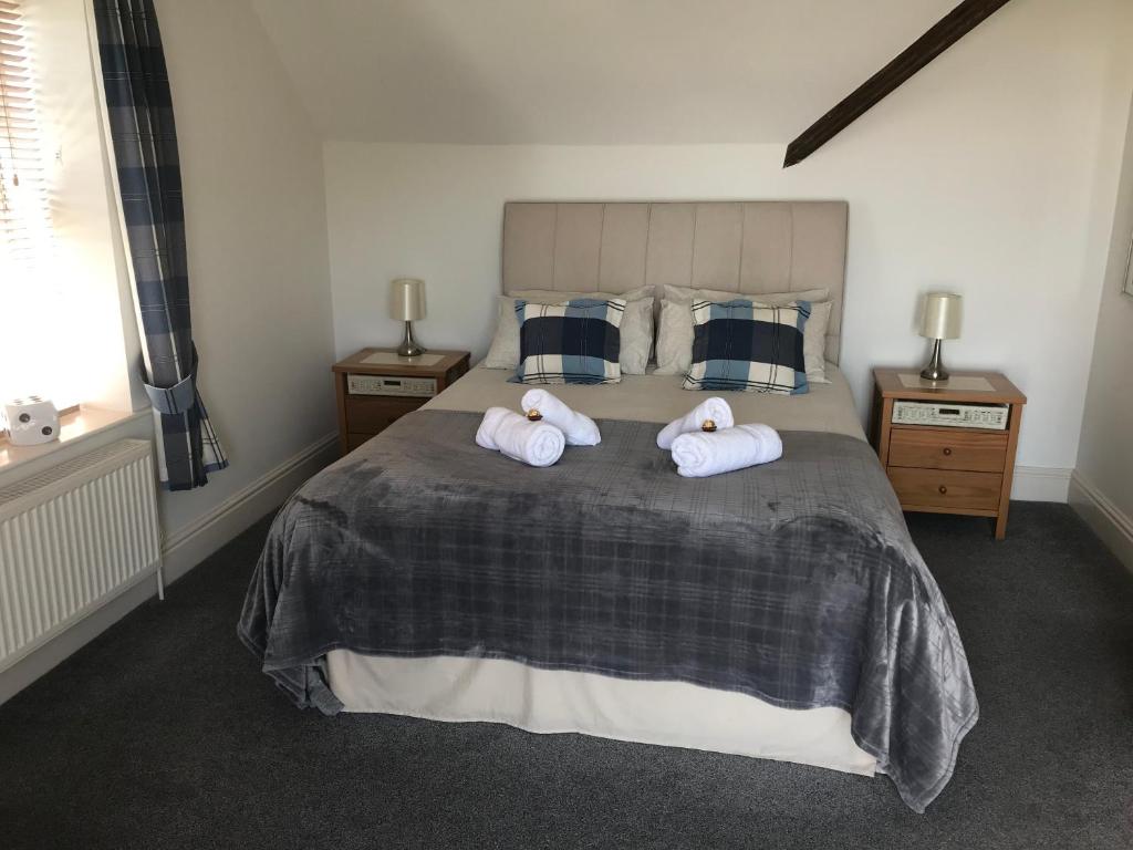 a bedroom with a bed with two towels on it at Southover Beach in Woolacombe