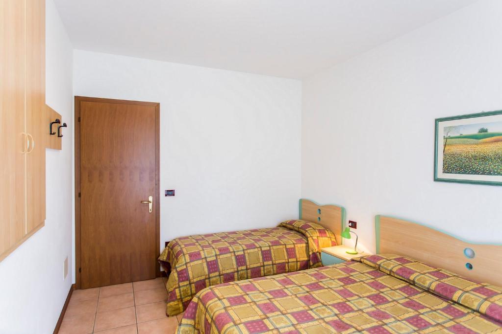 A bed or beds in a room at Villaggio Calycanthus