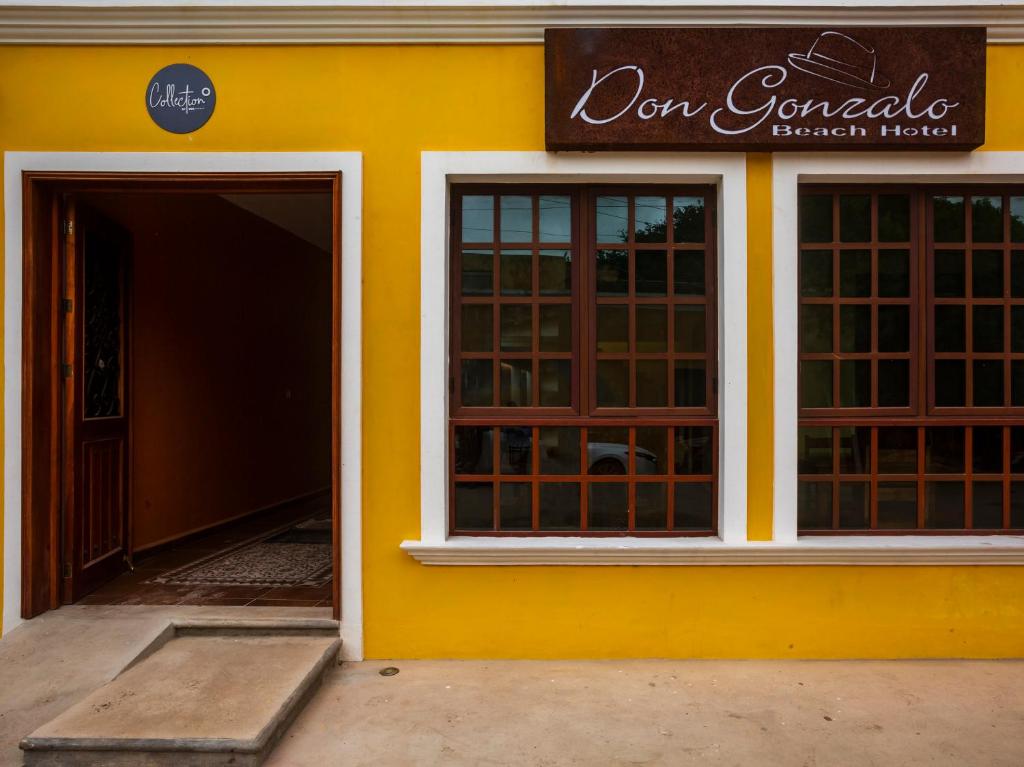 un bâtiment jaune avec une porte et une entrée dans l'établissement Hotel Beach Don Gonzalo, à Celestún