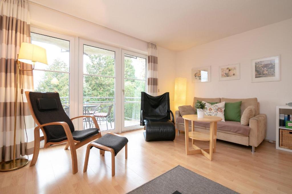 een woonkamer met een bank en een tafel en stoelen bij Seestraße 56 Wohnung 7 in Scharbeutz