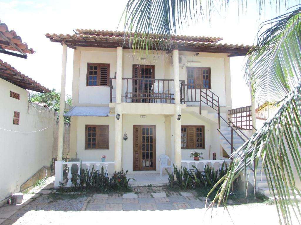 Una gran casa blanca con escaleras. en Apartamentos Casa Veneza, en Canoa Quebrada