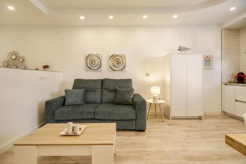 a living room with a couch and a table at Apartamento Naypa with free parking in Cádiz