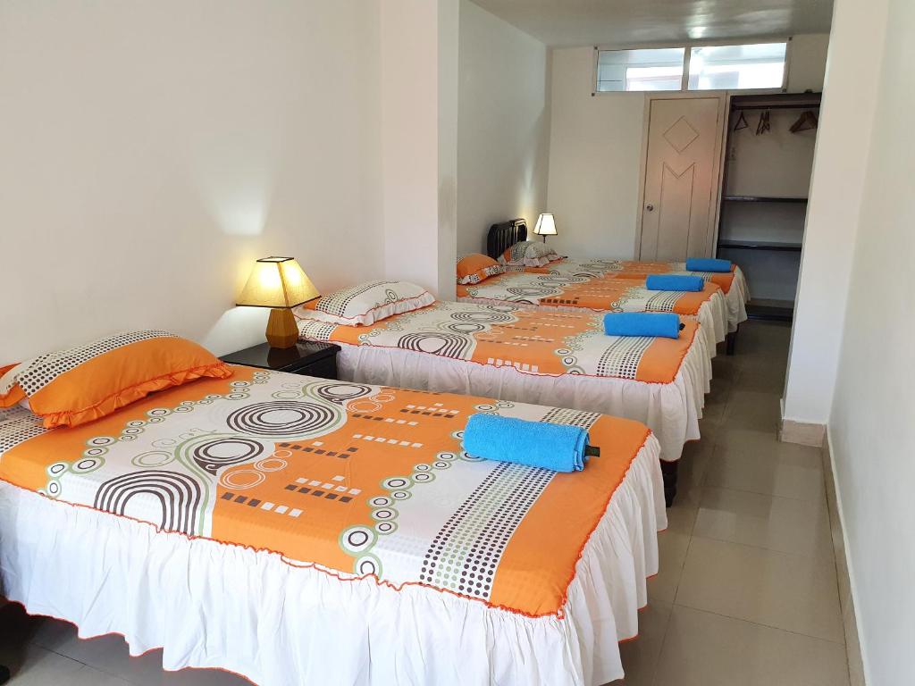Postel nebo postele na pokoji v ubytování Hostal Cerro Azul