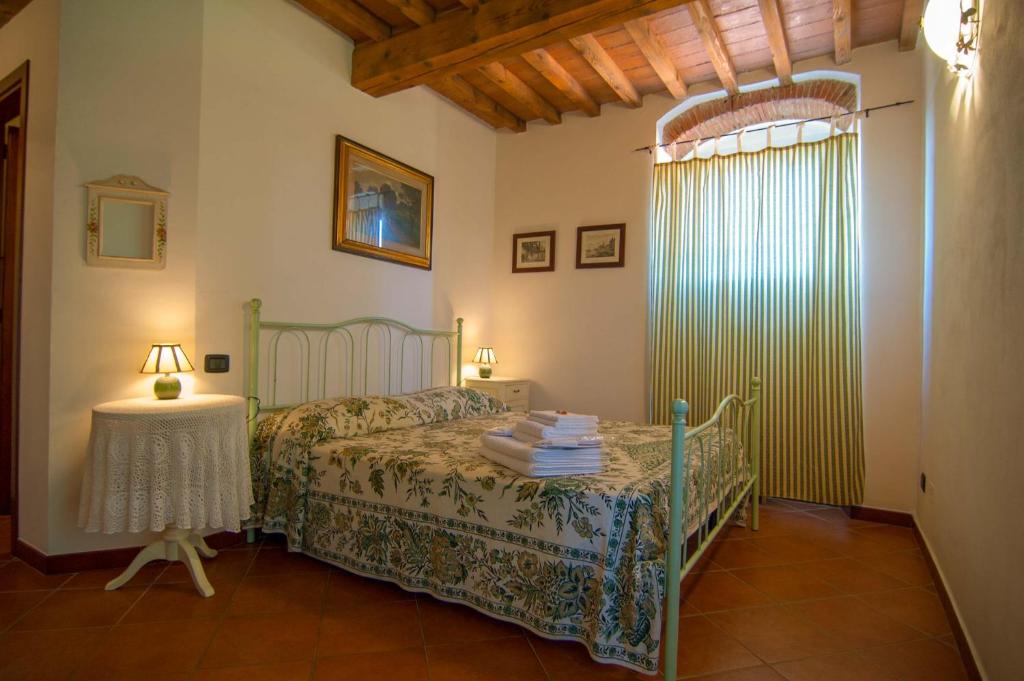 a bedroom with a bed and a table with a lamp at Arpaderba B&B in Livorno