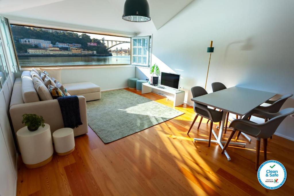 a living room with a table and a couch at Duplex Douro River in Porto