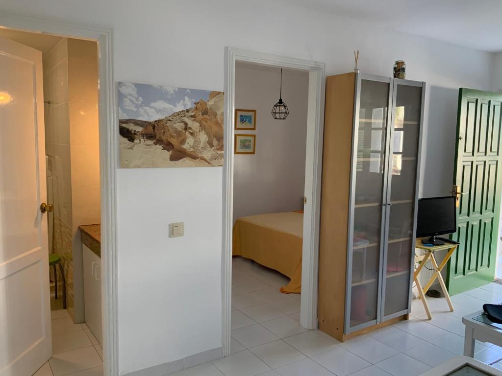 a room with a door leading to a bedroom at El bañadero in Cotillo