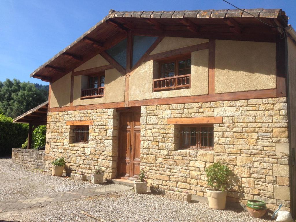 a stone building with windows and a wooden door at Les Reves B&B Chambres d'Hotes et Table d'Hotes in Arques