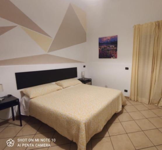 a bedroom with a bed in a room with at Fontanarossa Airport Home in Catania