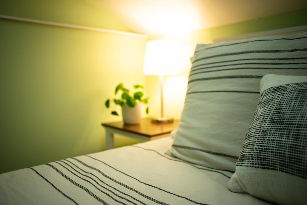 a bed with a pillow and a plant on a night stand at Black Walnut Bed and Breakfast in Interlaken