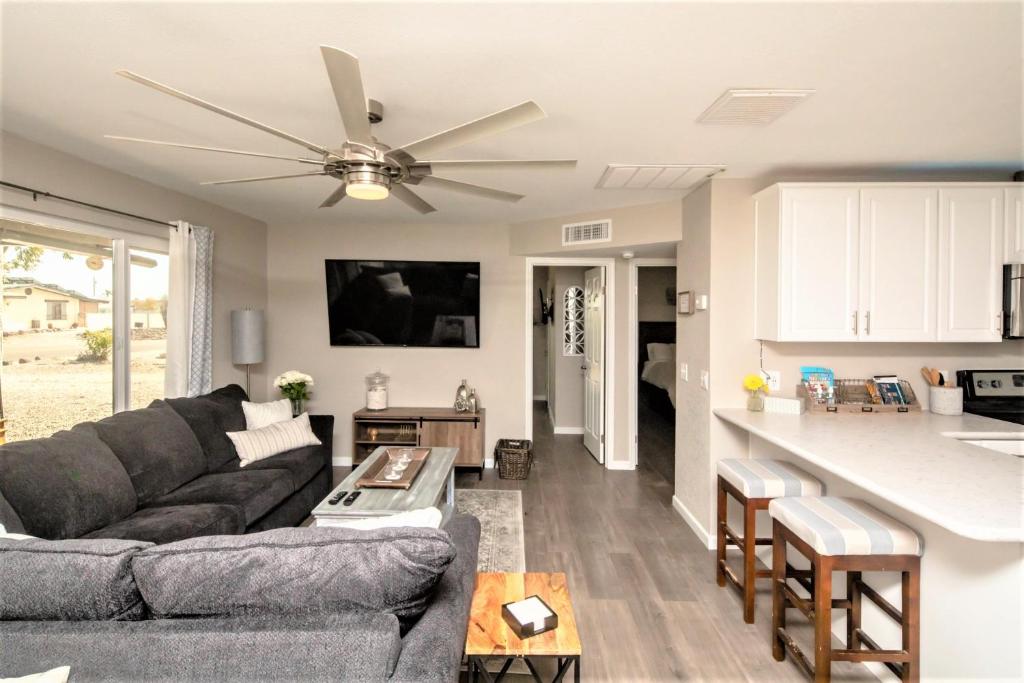 a living room with a couch and a ceiling fan at NEW! Family Lake Havasu Home Close To Off-Roading And London Bridge! in Lake Havasu City