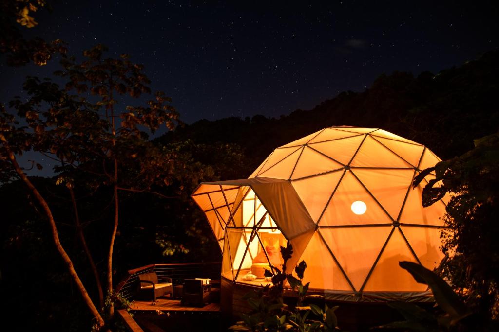a large geodesic dome building at night at Trekker Glamping in Minca